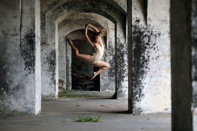 Side view of woman in abandoned building