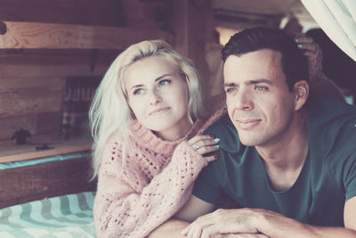 Smiling young couple relaxing in camper van