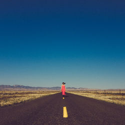 Man on road against clear sky