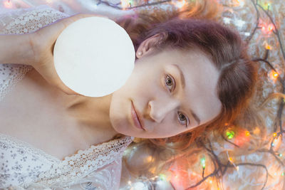 Close up glowing orb illuminating woman face portrait picture