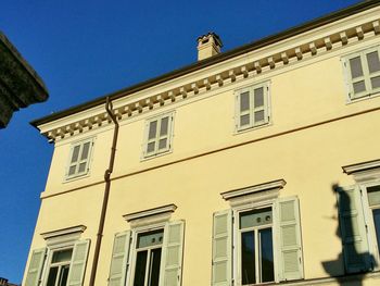 Low angle view of building against clear blue sky