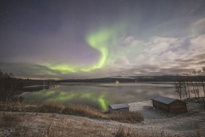 Northern lights in tromso norway over wooden house