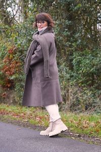 Rear view of woman standing on road