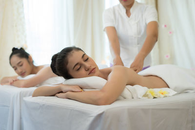 Young woman receiving massage in spa