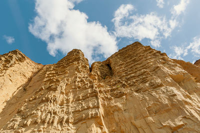 Low angle view of rock formations against sky