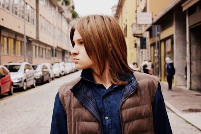 Young woman standing in front of buildings