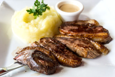 Close-up of steak and mashed potatoes served in plate