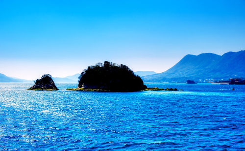 Scenic view of sea against clear blue sky