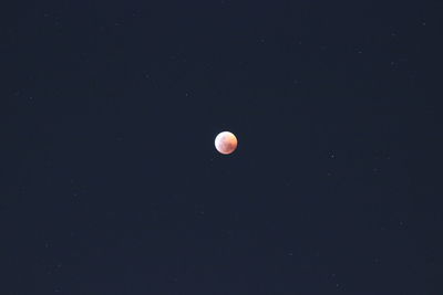 Low angle view of moon against sky at night