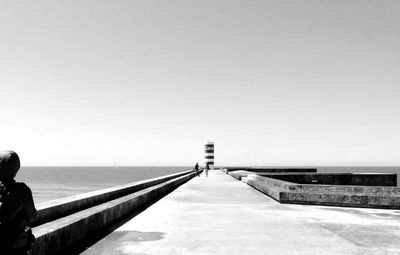 Pier on sea against clear sky