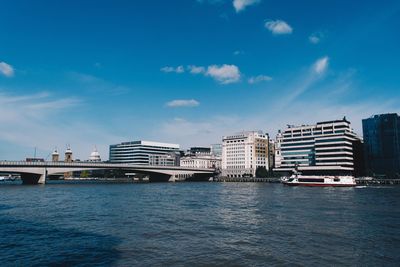 Scenic view of sea by buildings against sky