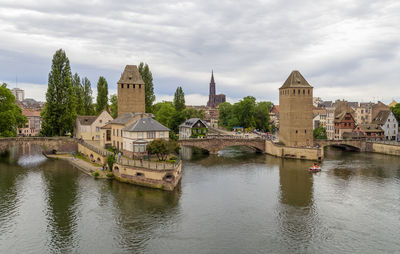 Arch bridge over river against sky