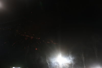 Low angle view of illuminated trees against sky at night