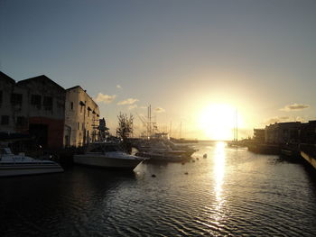 Boats in harbor at sunset