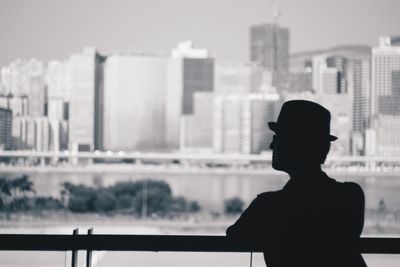 Man in cruise ship looking at cityscape