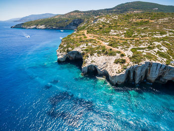 Scenic view of sea and mountains against sky