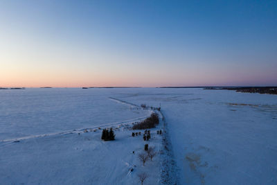 Scenic view of sea against clear sky during sunset