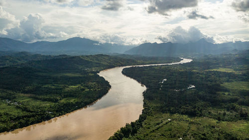 Scenic view of river amidst mountains against sky