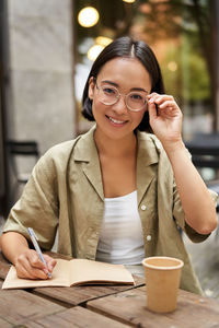 Portrait of young woman using mobile phone