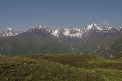 Scenic view of snowcapped mountains against clear sky