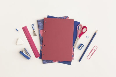 High angle view of pen and book on white background