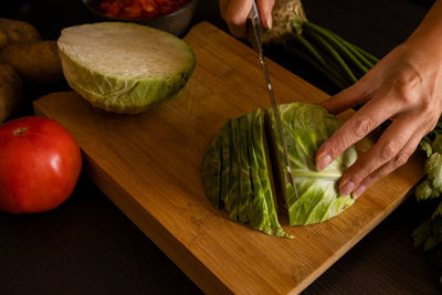 Midsection of man with vegetables on table