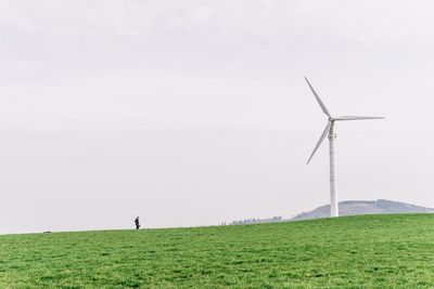 Wind turbines on grassy field