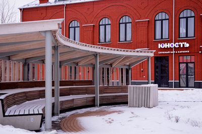 Snow covered house against building