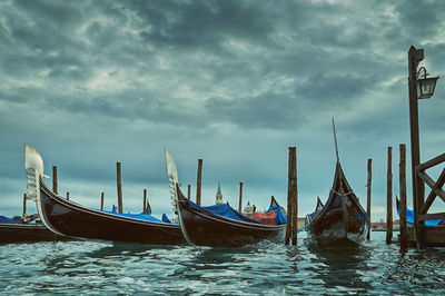 Boats moored in sea against sky