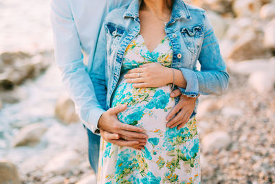 Midsection of woman holding hands