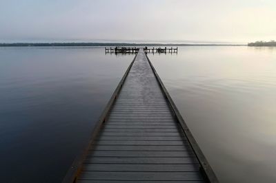 Pier over sea against sky