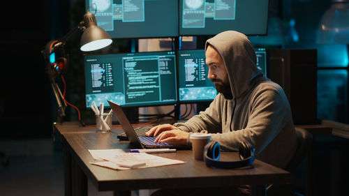 Midsection of woman using laptop on table