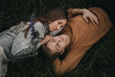 Young couple lying on grass