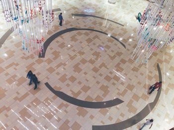 High angle view of woman on tiled floor