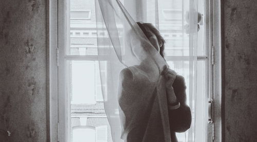 Man standing by window