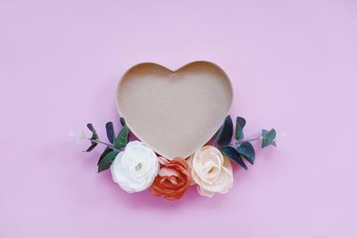 Directly above shot of rose bouquet against pink background