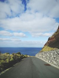 Road by sea against sky