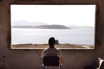 Rear view of man looking at beach