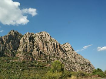 Low angle view of rocks on land against sky