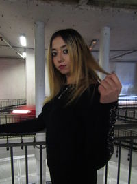 Portrait of beautiful young woman standing indoors