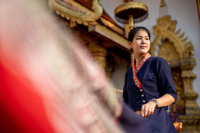 Full length of young woman standing at temple