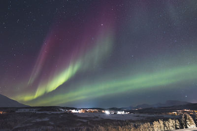 Scenic view of landscape against sky at night