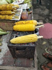 High angle view of yellow corn on bbq for sale at market