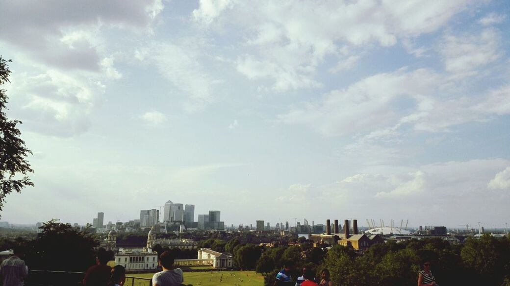 building exterior, architecture, built structure, city, sky, cityscape, cloud - sky, tree, cloudy, residential district, skyscraper, residential building, crowded, cloud, tower, city life, urban skyline, high angle view, day, residential structure