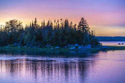 Scenic view of lake against sky at sunset