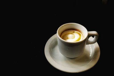 Close-up of coffee cup over black background