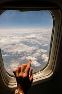 Woman seen through airplane window