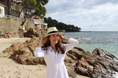 Young woman standing at beach
