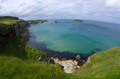 Scenic view of sea against cloudy sky