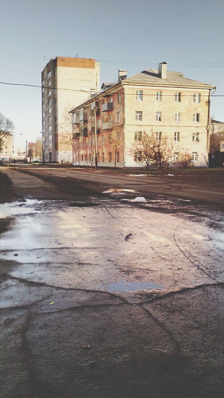 building exterior, architecture, built structure, city, street, building, residential building, residential structure, clear sky, transportation, road, sky, car, house, outdoors, residential district, day, city life, no people, city street